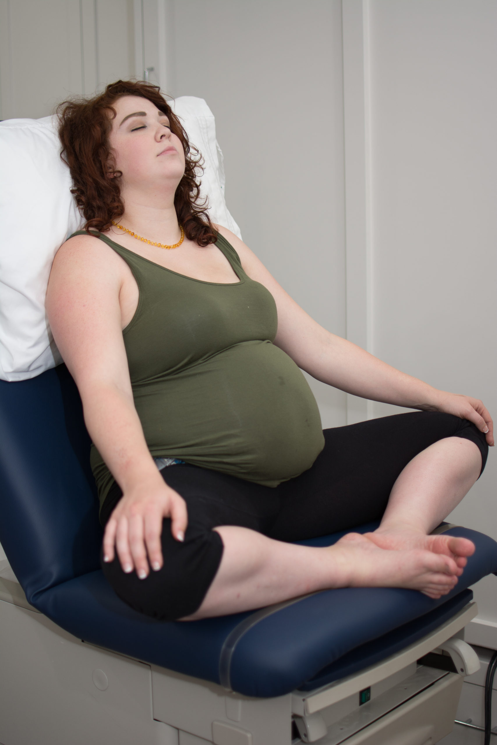 fertility doula services pregnant person sitting in medical office